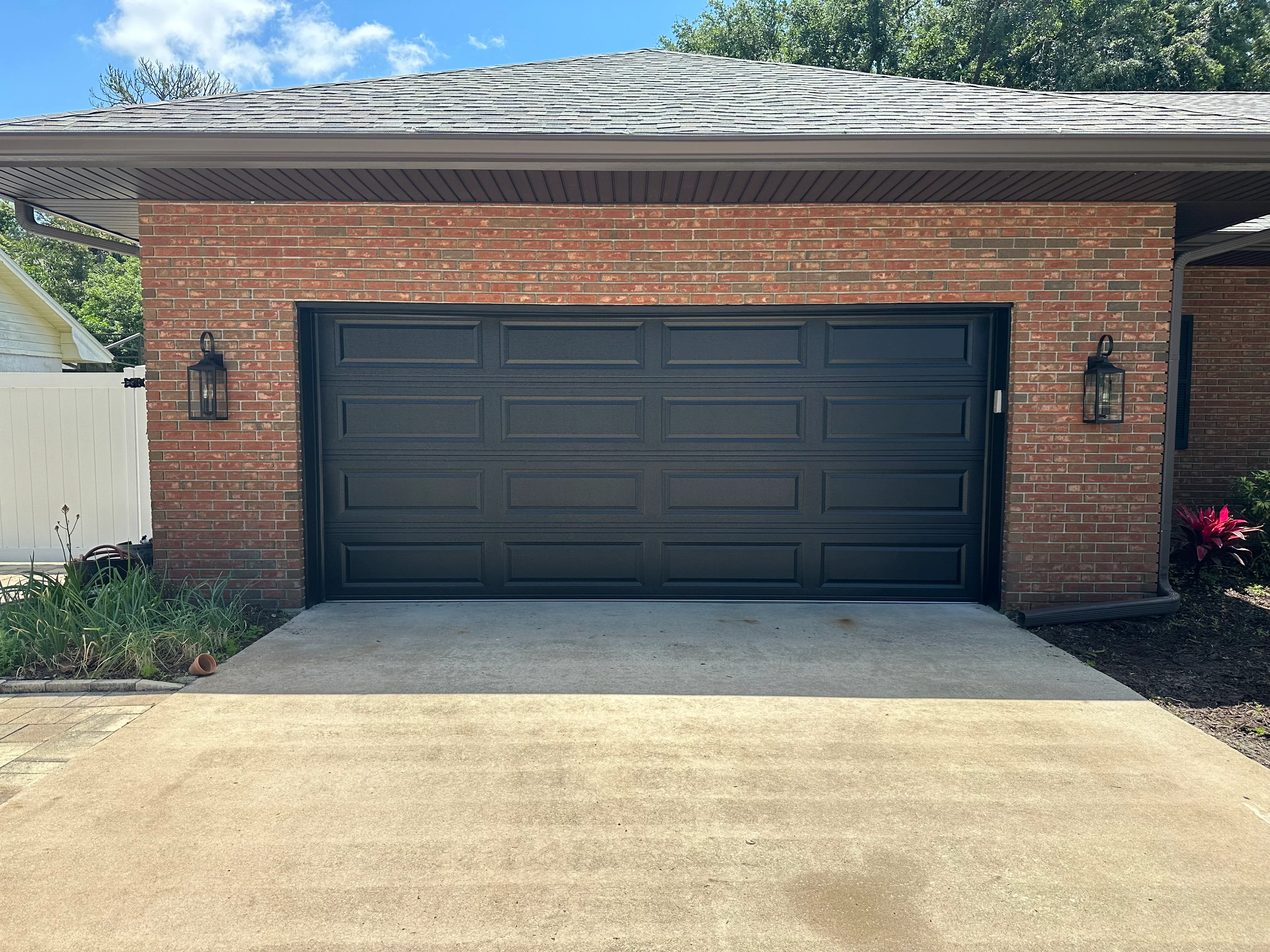 Garage door repair technician working on residential garage door in Palm Bay